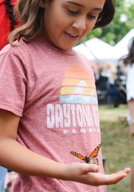 2023 Monarch festival - child with monarch in hand
