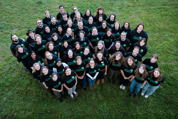 Group wearing black shirts with GreenCorps logo looking at camera