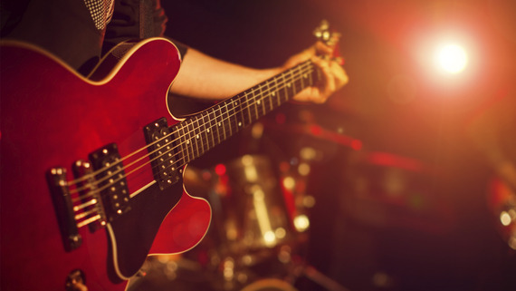 photo of person playing guitar