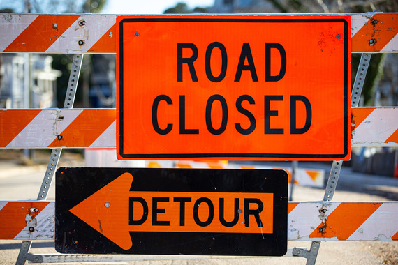 Image of a "Road Closed" sign with a detour arrow underneath