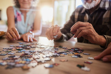 Two people doing a jigsaw puzzle together