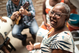 group of people playing music and laughing