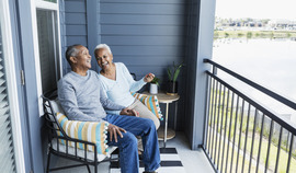 Couple on balcony laughing together