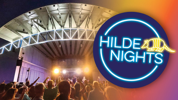 Image of a concert stage at night with yellow and purple lights and a cheering crowd. Text says "Hilde Nights" 