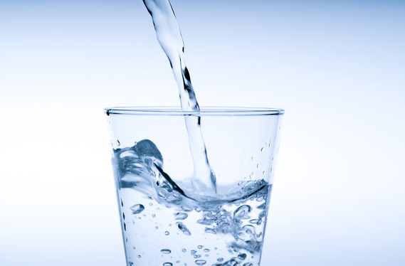 Closeup of a glass of water being poured