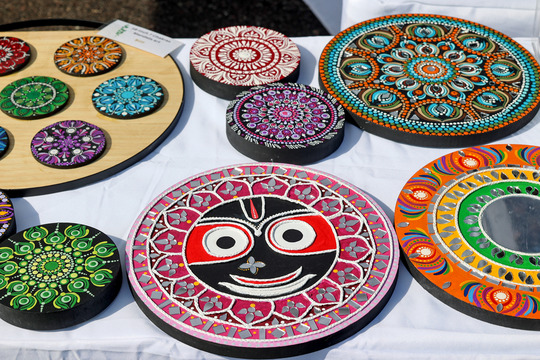 Photo of detailed, colorful mandala artwork sitting on a table.