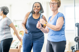 women zumba dancing in group fitness class