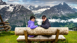 Travelers on bench in switzerland alps