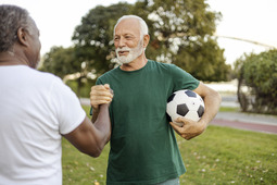 Man with soccer ball giving high five
