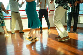 Adults dancing from waist down in a dance studio