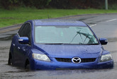 car stuck on road in a flash flood