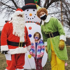 Millie Frethem with Santa and Buddy the Elf at the Sprinkler Fitters drive thru food drive event in Shoreview.
