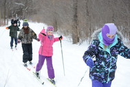 Children learning to ski on snowy trail
