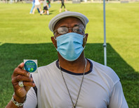 Resident holding vaccine sticker