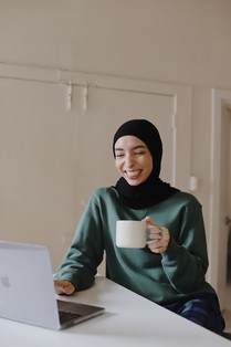 Woman on computer with coffee