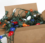 Multicolored holiday string lights in a cardboard box