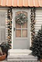 Front door decorated with holiday wreath and garland