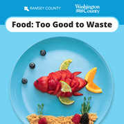A blue plate with a fish made out of cut-up fruit. Text reads "Food: Too Good to Waste"