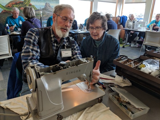 Fixer helps resident fix sewing machine