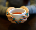 Hands holding cup of warm tea