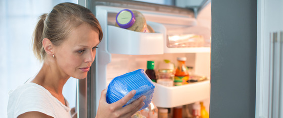 Women looking at food in her fridge