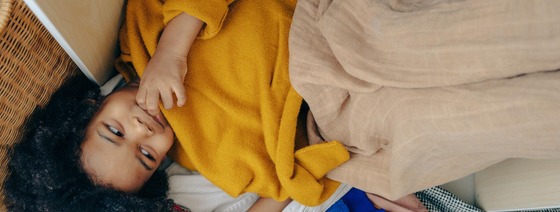 Child laying in pile of clothing