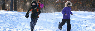 Kids playing in snow with snowshoes at Tamarack Park