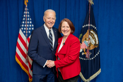 Commissioner McGuire posing with President Biden