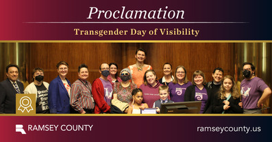 Photo of Commissioners with community members celebrating Trans Visibility Day