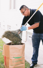 Man putting yard waste in a bag