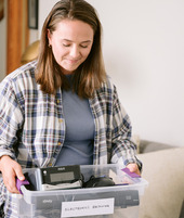 Woman holding a box of electronics