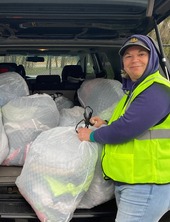 Person loading up old textiles into car