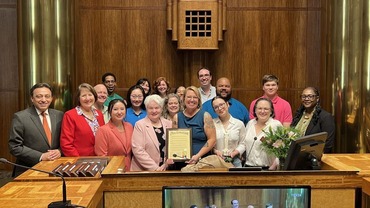 Photo with Trista Martinson, Board, and other staff for proclamation of Trista Martinson Day