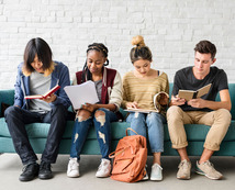 Youth reading on a bench