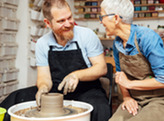 Two people making pottery together