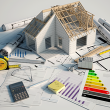 A hard hat and blue prints of a house