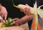 Person shucking corn