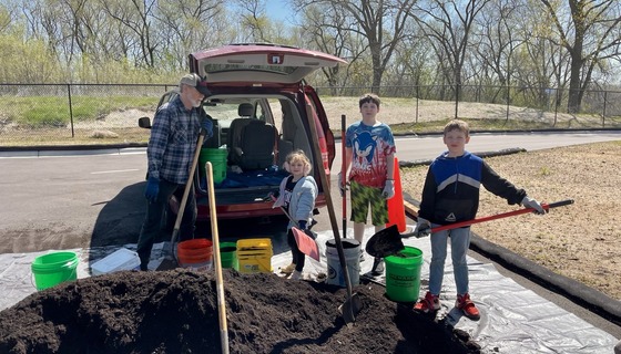 Family gathering compost from pile