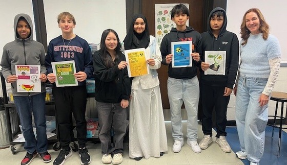 Mrs. Crowley and students at Murry Middle School display posters about radon