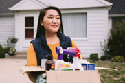 Woman carrying box of household hazardous waste