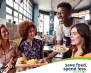 Four people eating at a restaraunt with the Save Food, Spend Less Challenge logo in the bottom right corner