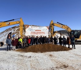 Group of people at construction site doing a groundbreaking for a project