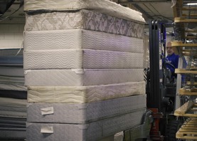 Pile of mattresses getting prepared to be recycled