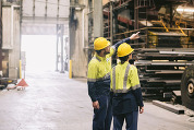 Two people in facility wearing PPE