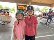 kids with helmets at farmers market