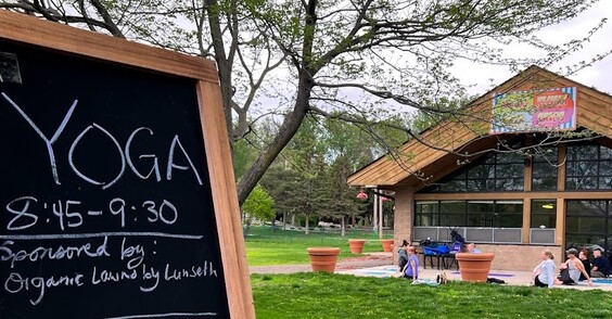 Yoga at the Market with chalkboard sign