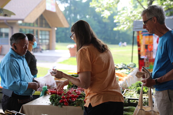 Healthy Green - Yee Moua - customers buying radishes at the Richfield Farmers Market