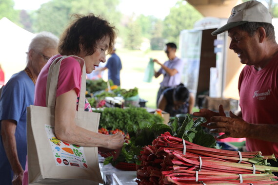 Peter's Pumpkins chatting with customers at farmers market
