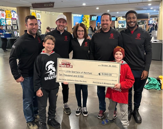 Richfield Little Spartans Hockey accepting 10,000 check at Wild game