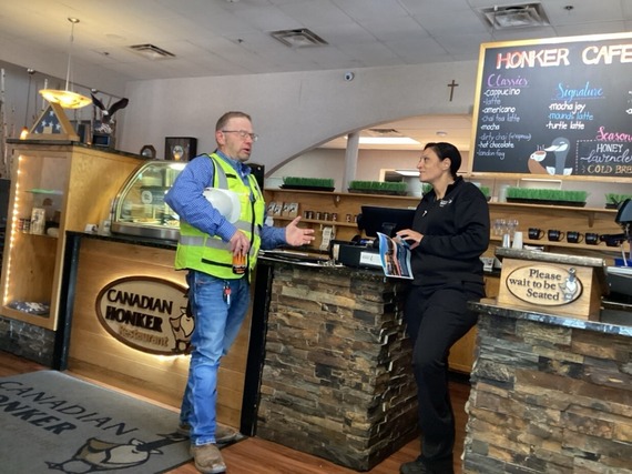 Construction worker speaking to business worker.